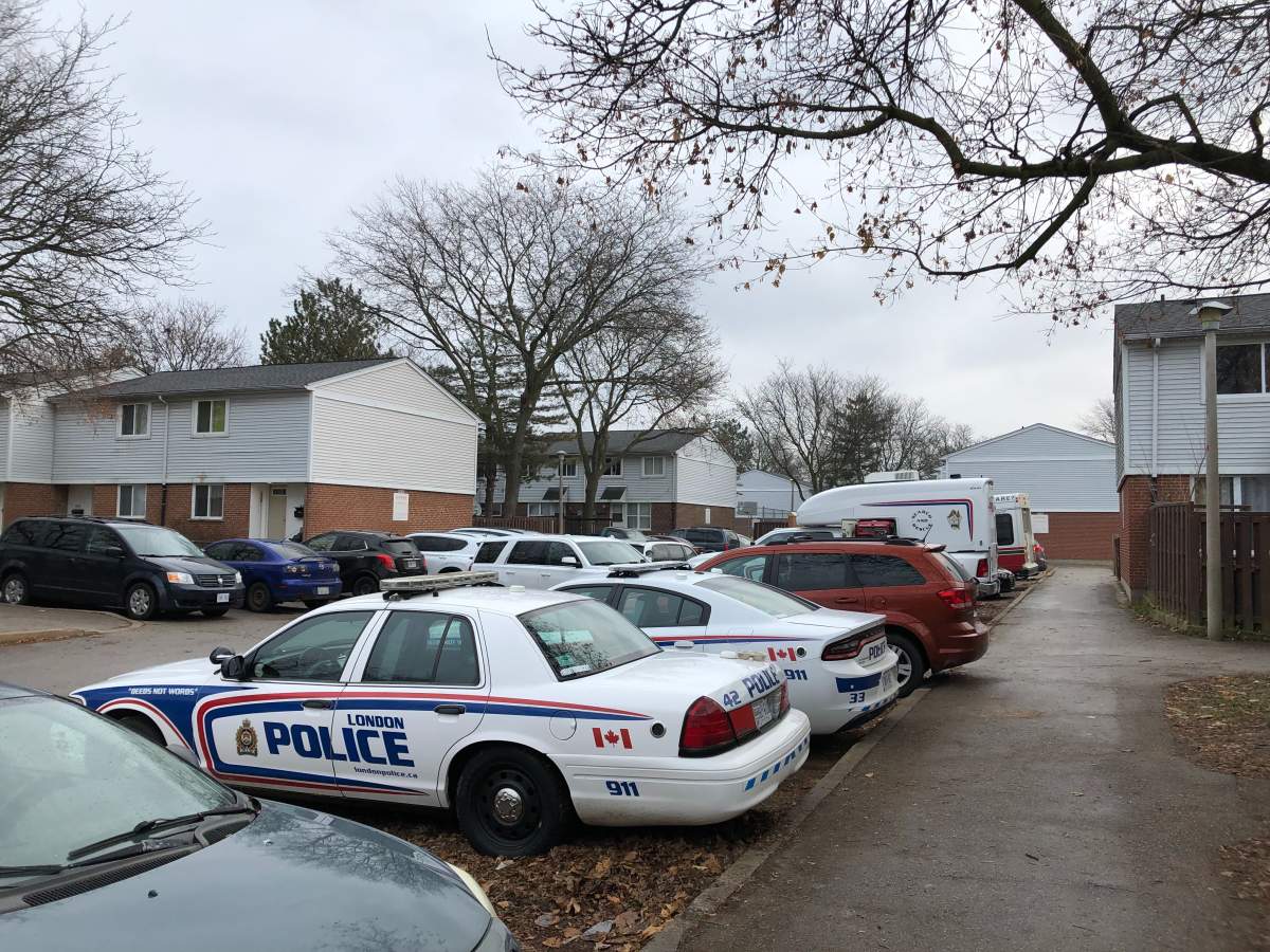 Police cruisers fill a complex on Millbank Drive, south of Southdale Road East, following report of a shooting Sunday night.