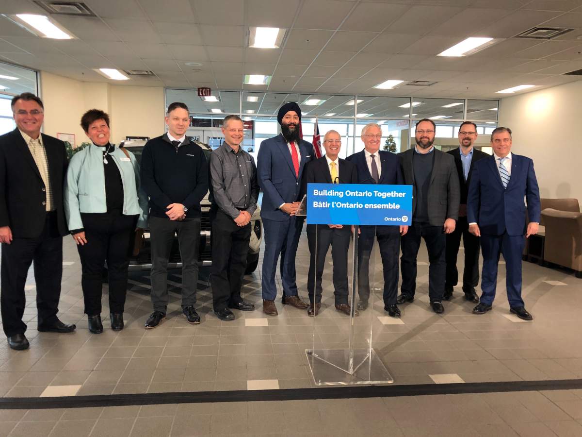 Vic Fedeli (yellow tie), Flavio Volpe (two right of Fedeli) at Toyota Woodstock Thursday morning.