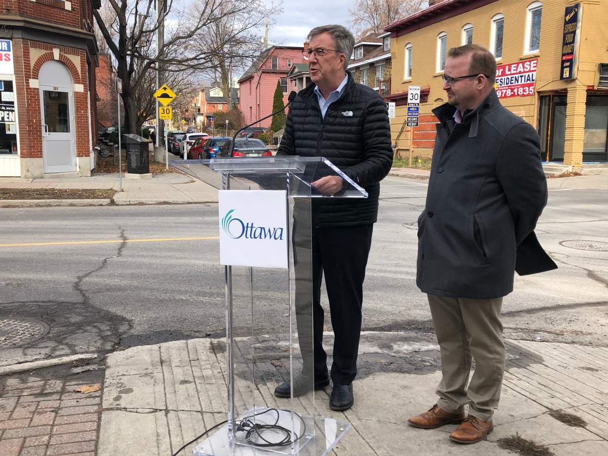 Ottawa Mayor Jim Watson and transportation committee chair Coun. Stephen Blais outline the city's new five-year action plan on road safety at a downtown intersection on Monday, Nov. 25, 2019.