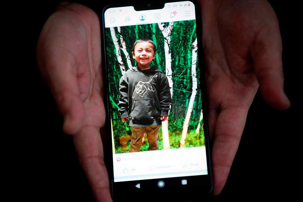 Bianca Smith, aunt of Hunter Straight-Smith, holds a photo of the three-year-old who was allegedly stabbed by his mother’s ex-boyfriend. THE CANADIAN PRESS/John Woods