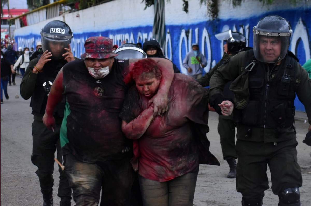 Police rescue Vinto mayor Patricia Arce Guzman after people threw paint and dirt on her following a fire in Vinto’s Town Hall, Quillacollo, Bolivia, Nov. 6, 2019, in this image obtained from Los Tiempos Bolivia social media.