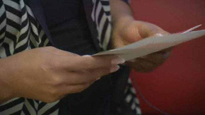 Linda Johnson, of Saskatoon, holds a card with messages written for Makwa Sahgaiehcan First Nation children.