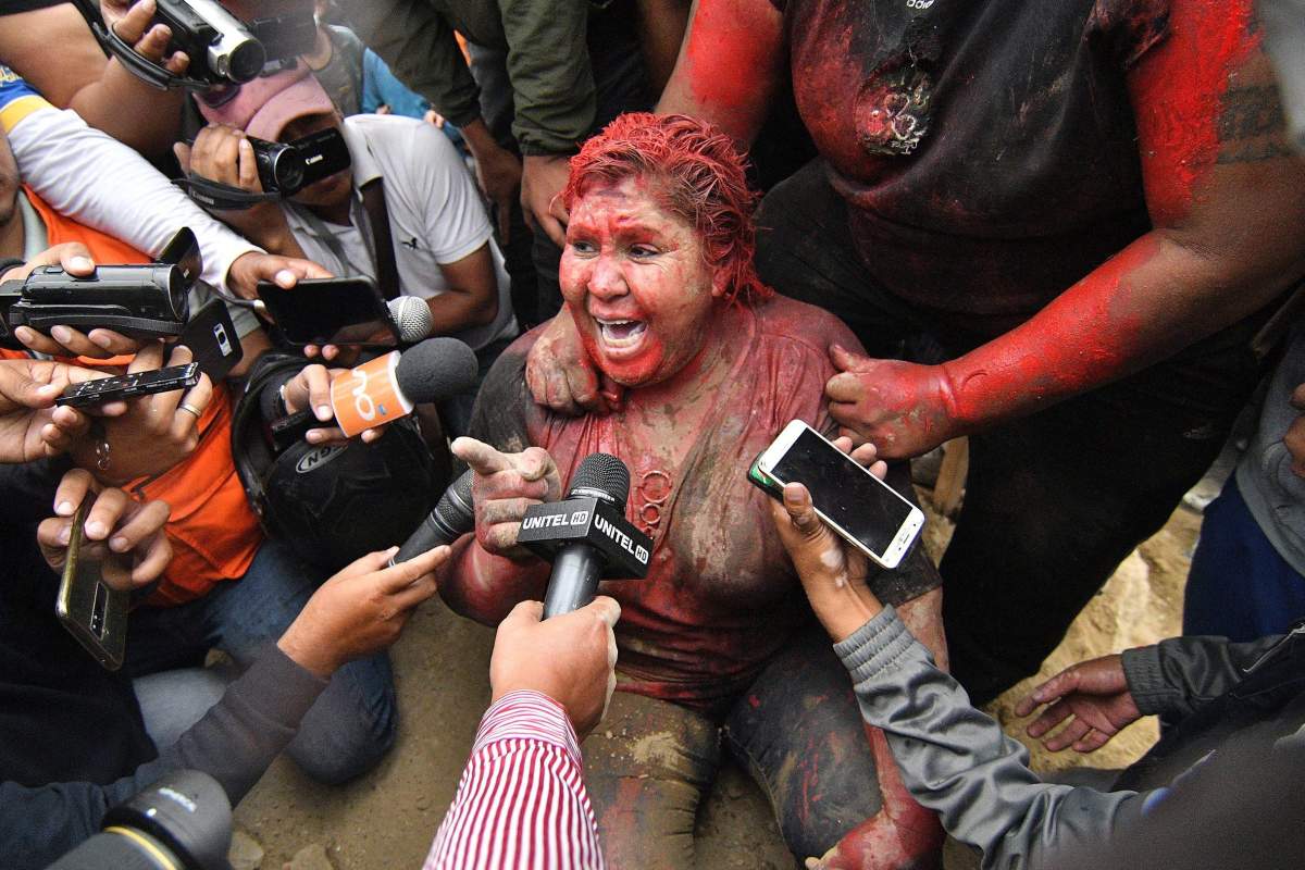 Mayor of Vinto, Patricia Arce, speaks to the media after being attacked in the street by a crowd that sprayed her with reddish paint and cut her hair in Vinto, Bolivia, Nov. 6, 2019.