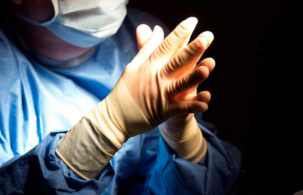 FILE - In this Tuesday, June 28, 2016 file photo, a doctor prepares for a surgical procedure at a hospital in Washington. 