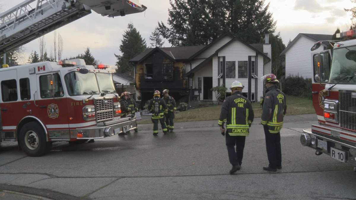 Crews mop up after a house fire in Surrey on Wednesday morning. 