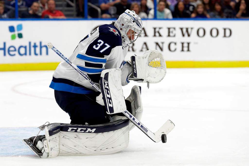 Winnipeg Jets goaltender Connor Hellebuyck (37) makes a save on a shot by the Tampa Bay Lightning during the second period of an NHL hockey game Saturday, Nov. 16, 2019, in Tampa, Fla. (AP Photo/Chris O'Meara).