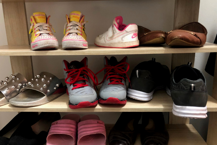 Shoes line shelves placed by the entrance of Nisa Homes’ Mississauga, Ont. location.