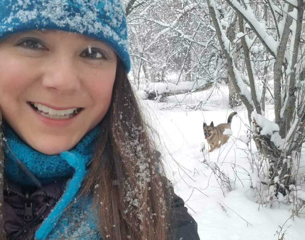 Daintre Christensen and her dog Virgil walking in in the woods.