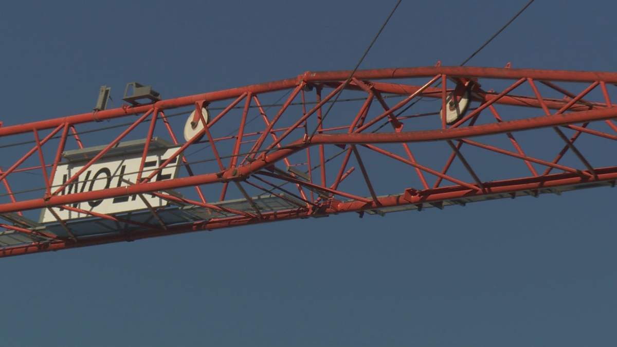 Pictures from the scene show a bent steel strut in the bottom of the crane's jib arm.