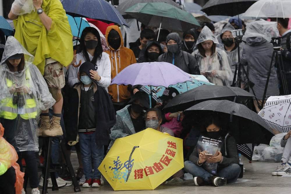 Protesters sit down near an umbrella with the words "Support freedom, Against Evil Law" during a rally in Hong Kong on Sunday, Dec. 29, 2019. Protests that began in June over a proposed extradition law have spread to include demands for more democracy and other grievances. 
