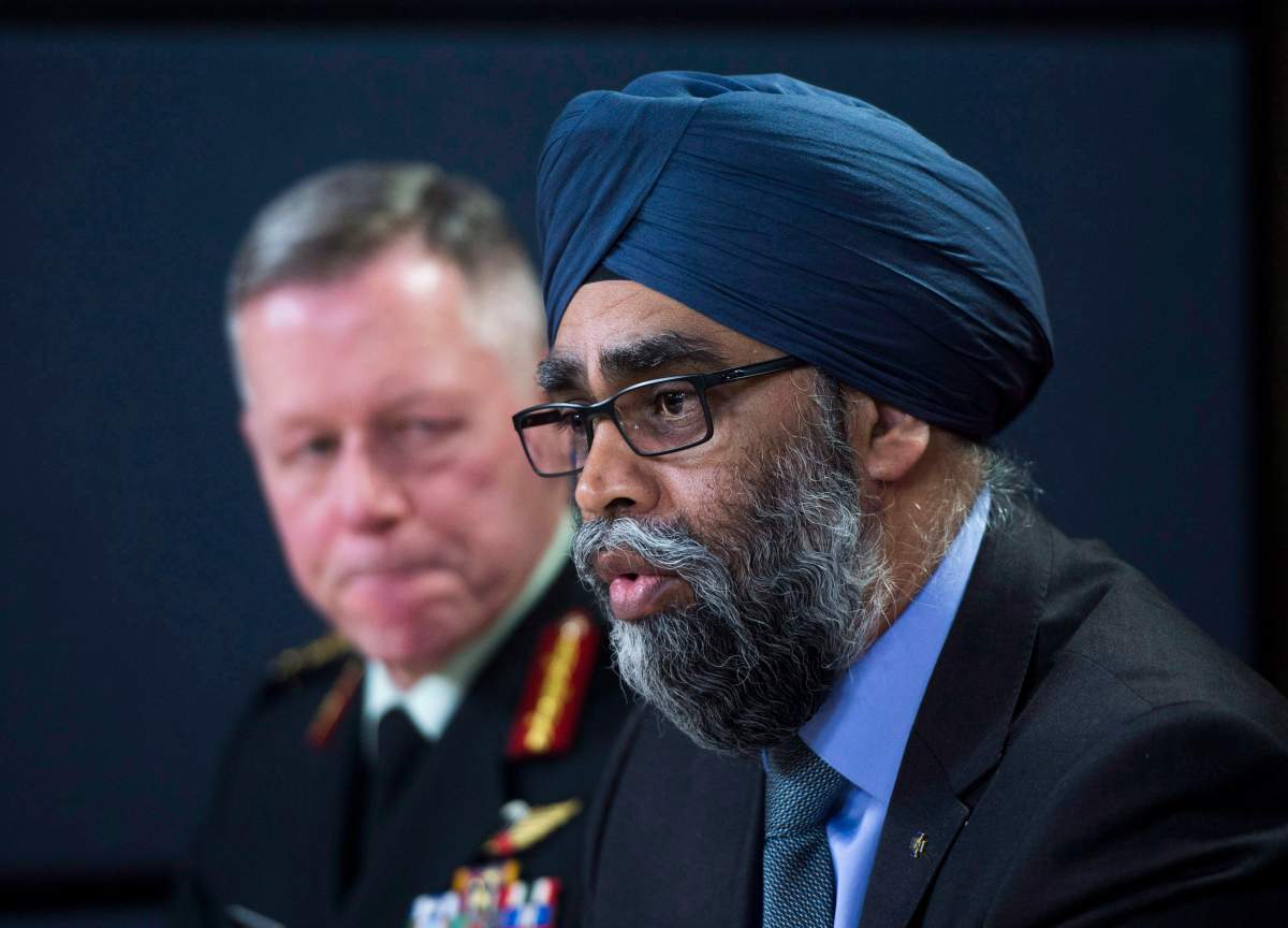 Defence Minister Harjit Sajjan speaks at an announcement on fighter jets as General Jonathan Vance, Chief of the Defence Staff (left) looks on at the National Press Theatre in Ottawa on Tuesday, Dec. 12, 2017. 