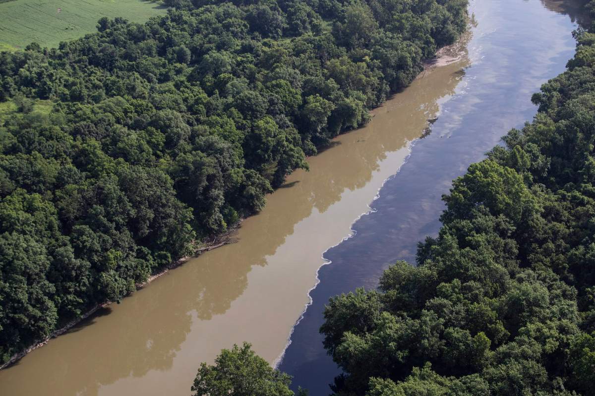Bourbon mixes with water in the Kentucky River, Wednesday, July 3, 2019, following an overnight fire at a Jim Beam distillery in Woodford County, Ky.