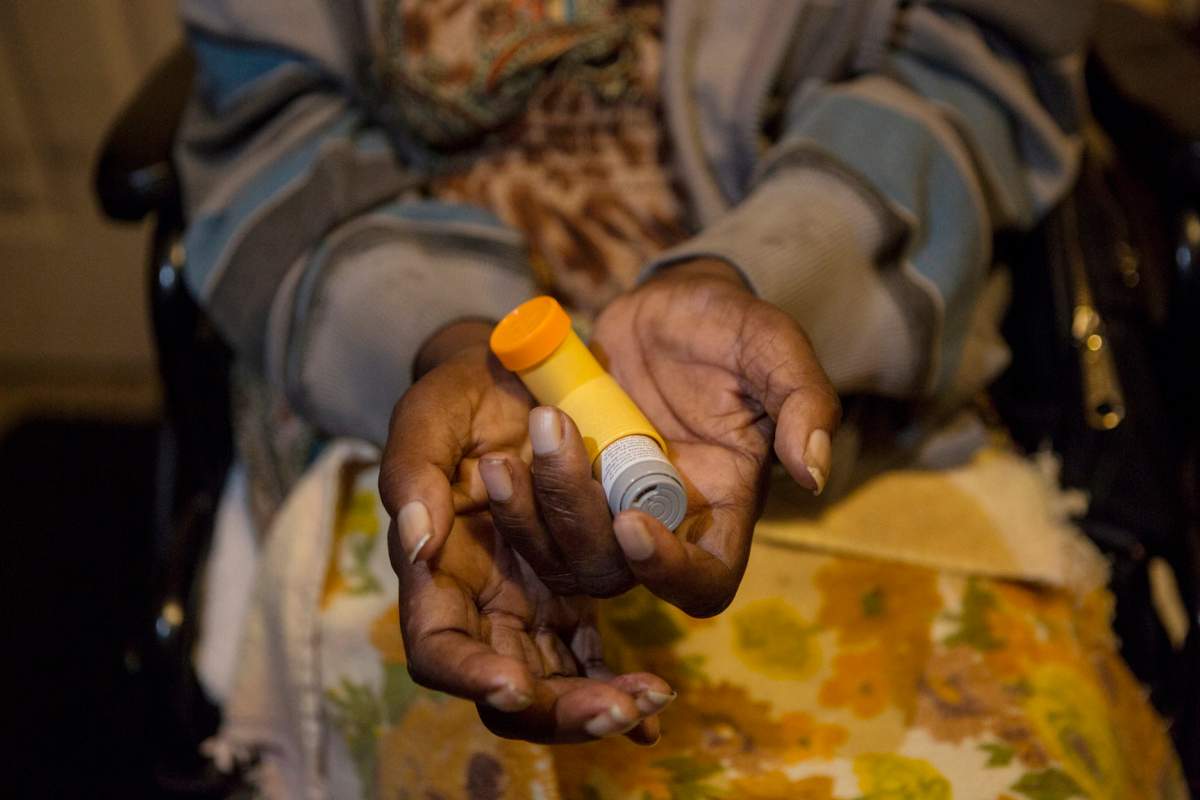 In this Nov. 4, 2019 photo, Annie Young, who suffers from asthma, shows her inhaler at her home in Pahokee, Fla.