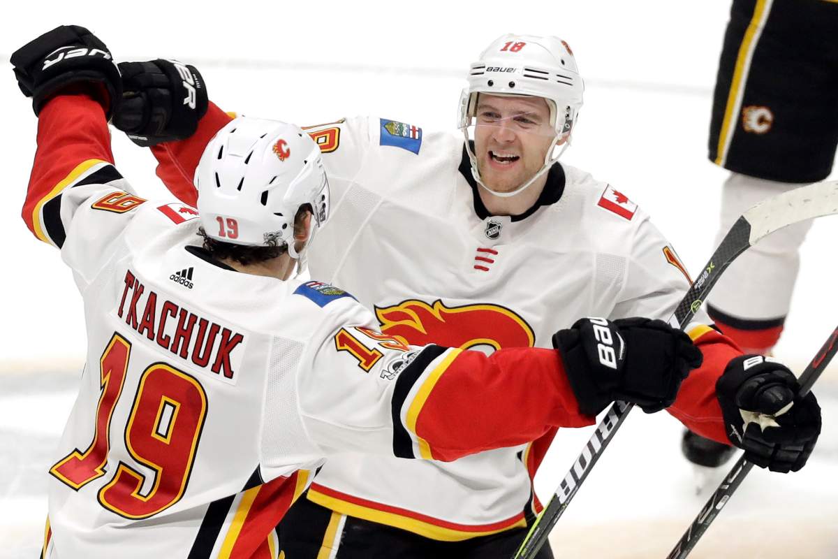 In this Oct. 24, 2017, file photo, Calgary Flames left wing Matthew Tkachuk (19) celebrates with center Matt Stajan (18) after Tkachuk scored the winning goal against the Nashville Predators during a shootout in an NHL hockey game in Nashville, Tenn.  