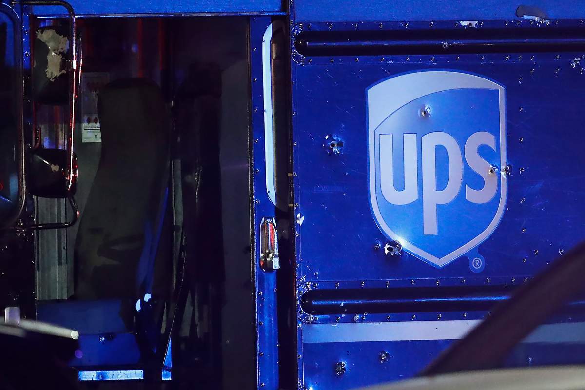 Bullet holes are seen around the UPS logo on a truck at the scene of a shooting Thursday, Dec. 5, 2019, in Miramar, Fla. Four people, including a UPS driver, were killed Thursday after robbers stole the driver’s truck and led police on a chase that ended in gunfire at a busy Florida intersection during rush hour, the FBI said. (AP Photo/Brynn Anderson)
