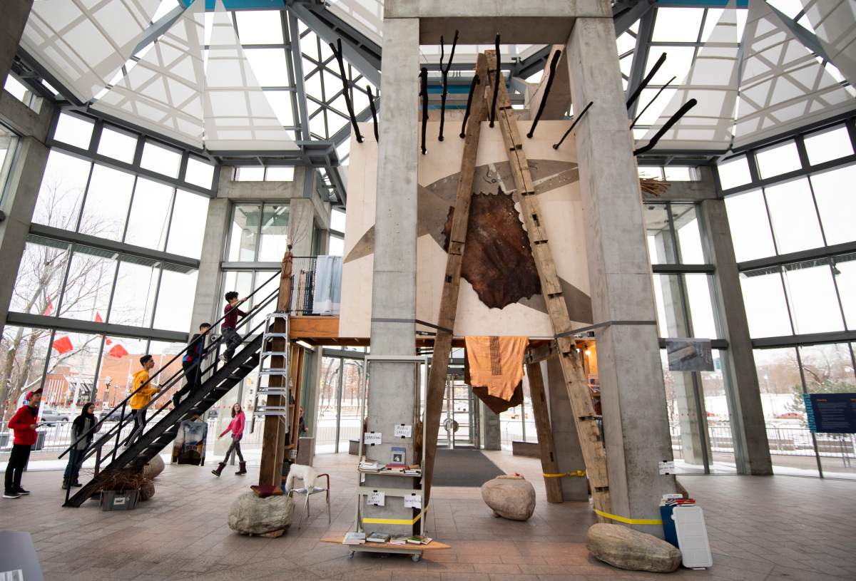 Joar Nango's Sami Architectural Library, part of Àbadakone, an exhibit of contemporary Indigenous art, is installed among the pillars at the entrance of the National Gallery of Canada in Ottawa, on Friday, Dec. 6, 2019. The structure, made of found and repurposed materials, contains a library with books on Indigenous architecture and activism.