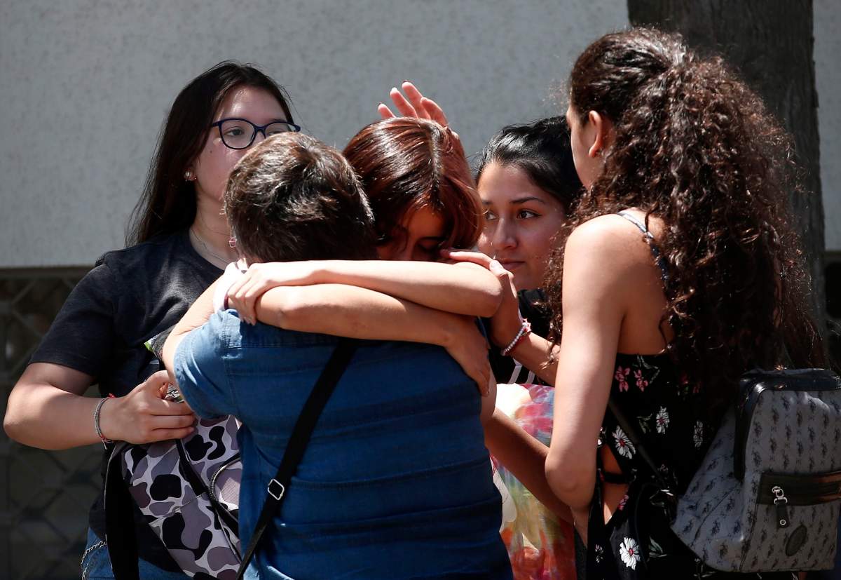 Relatives of passengers of a missing military plane comfort each other as they arrive at the Cerrillos airbase in Santiago, Chile, Dec. 10, 2019.