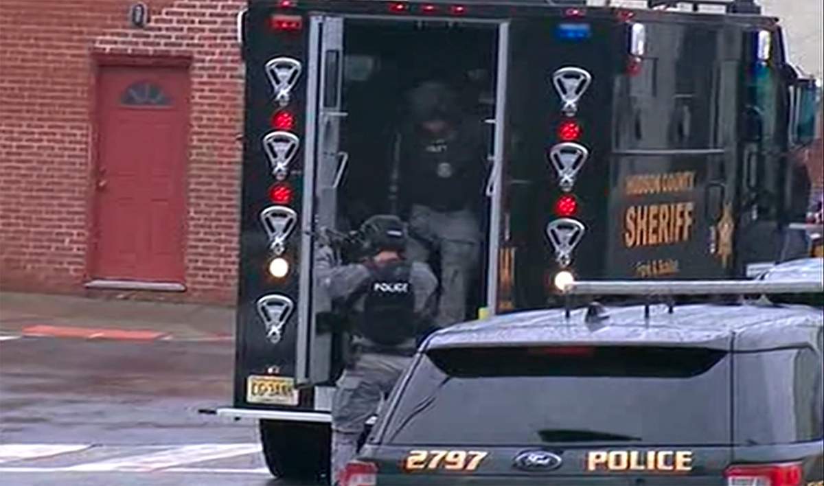 In this image taken from video, Hudson County Swat team officers arrive at the scene following reports of gunfire Dec. 10, 2019, in Jersey City, N.J.