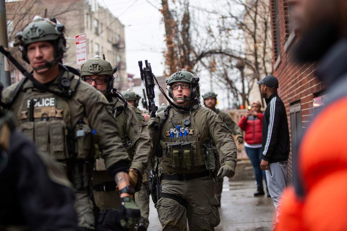 Police officers arrive at the scene following reports of gunfire, Dec. 10, 2019, in Jersey City, N.J.