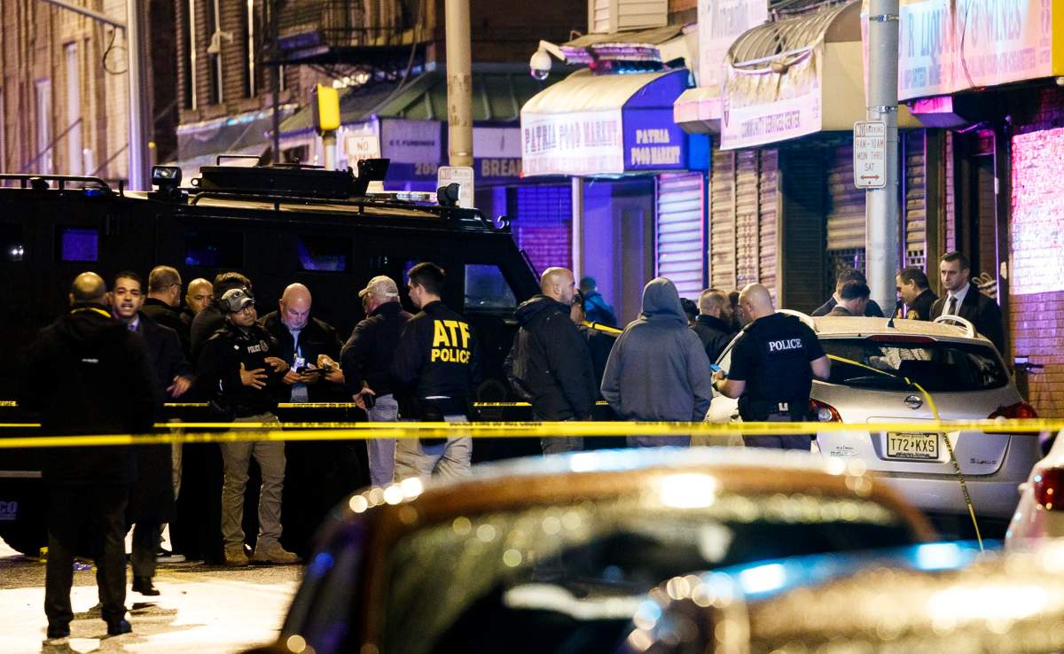 Police secure and investigate the scene of a shooting in Jersey City, New Jersey, USA, Dec. 10, 2019.