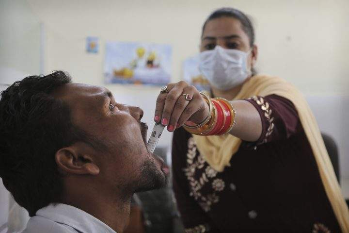 In this Thursday, Oct. 31, 2019, photo, a medic administers medicine to a recovering drug addict at a de-addiction center in Kapurthala, in the northern Indian state of Punjab.