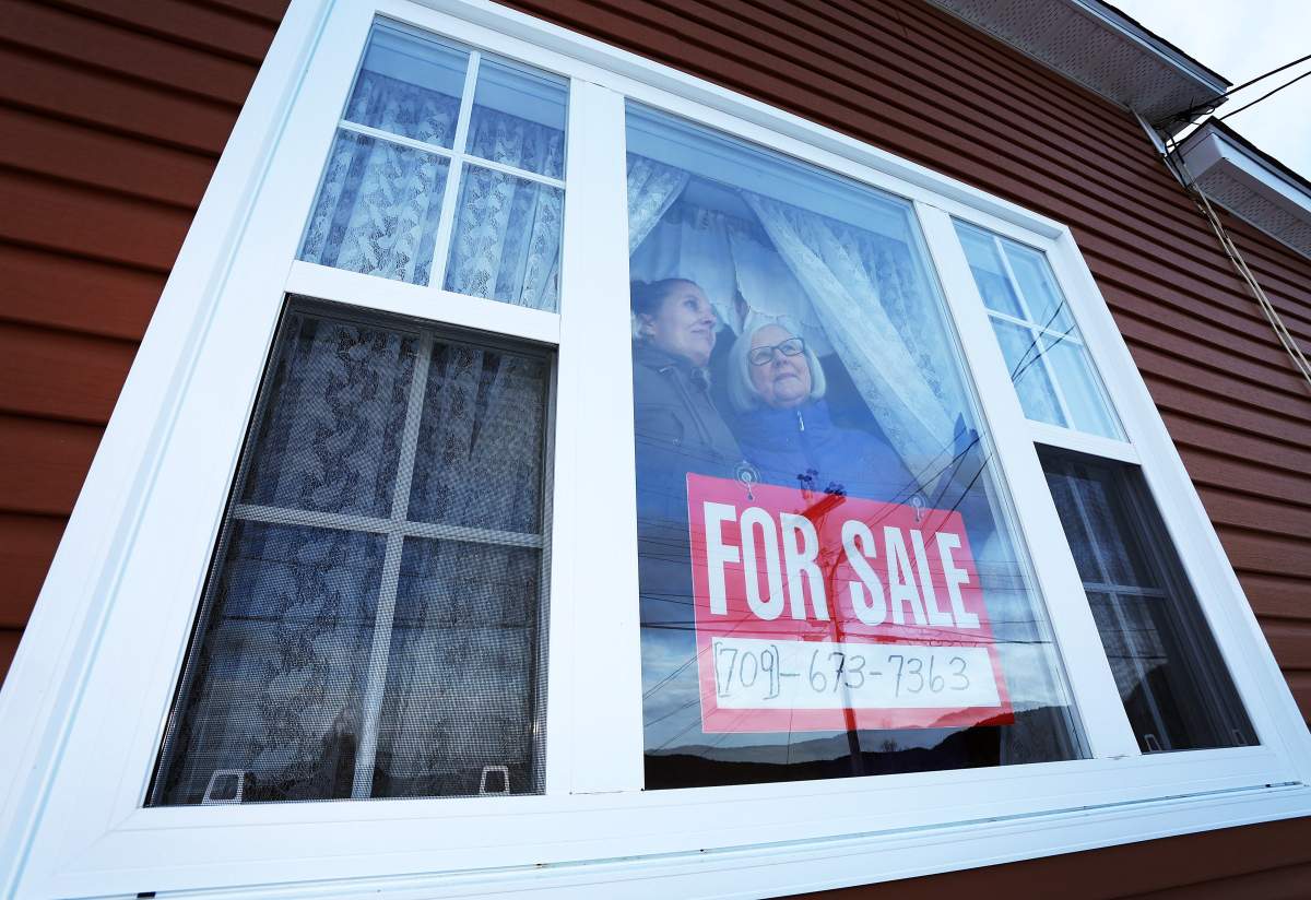 Pam Wiseman and her mother Cavell look out the window of the family home in Little Bay Islands, N.L. on Friday, November 15, 2019.