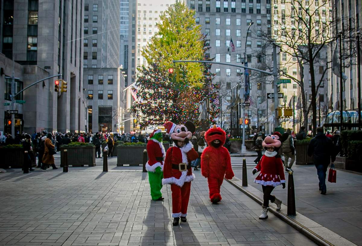 In this Dec. 20, 2019 photo, costumed performers leave Rockefeller Center in New York.