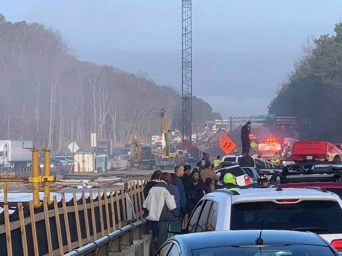 Drivers and emergency personnel remain on the scene of a multi-vehicle pileup on Interstate 64 in York County, Va., Sunday, Dec. 22, 2019.