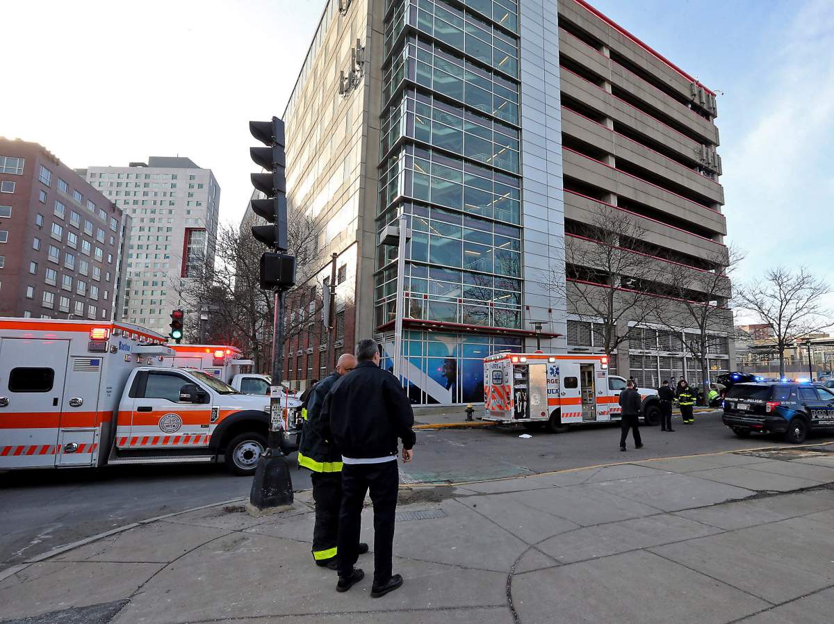 Emergency personnel at the scene of an incident at the Renaissance Park Garage where an adult and 2 children fell from the garage and were found dead on a sidewalk near the Boston parking garage on Christmas Day, Wednesday, Dec. 25, 2019.