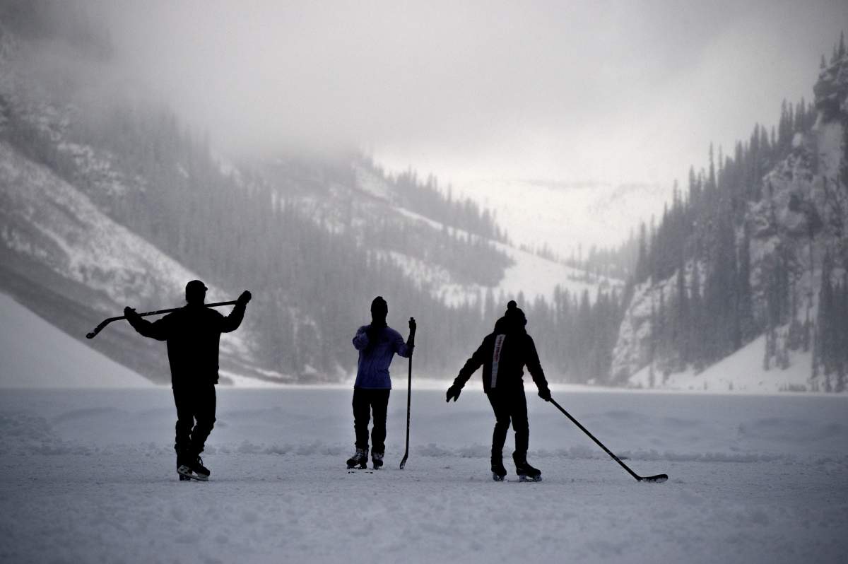 Hockey players make the most of the fading daylight as they skate on Lake Louise, Alta., Wednesday, Dec. 4, 2019.