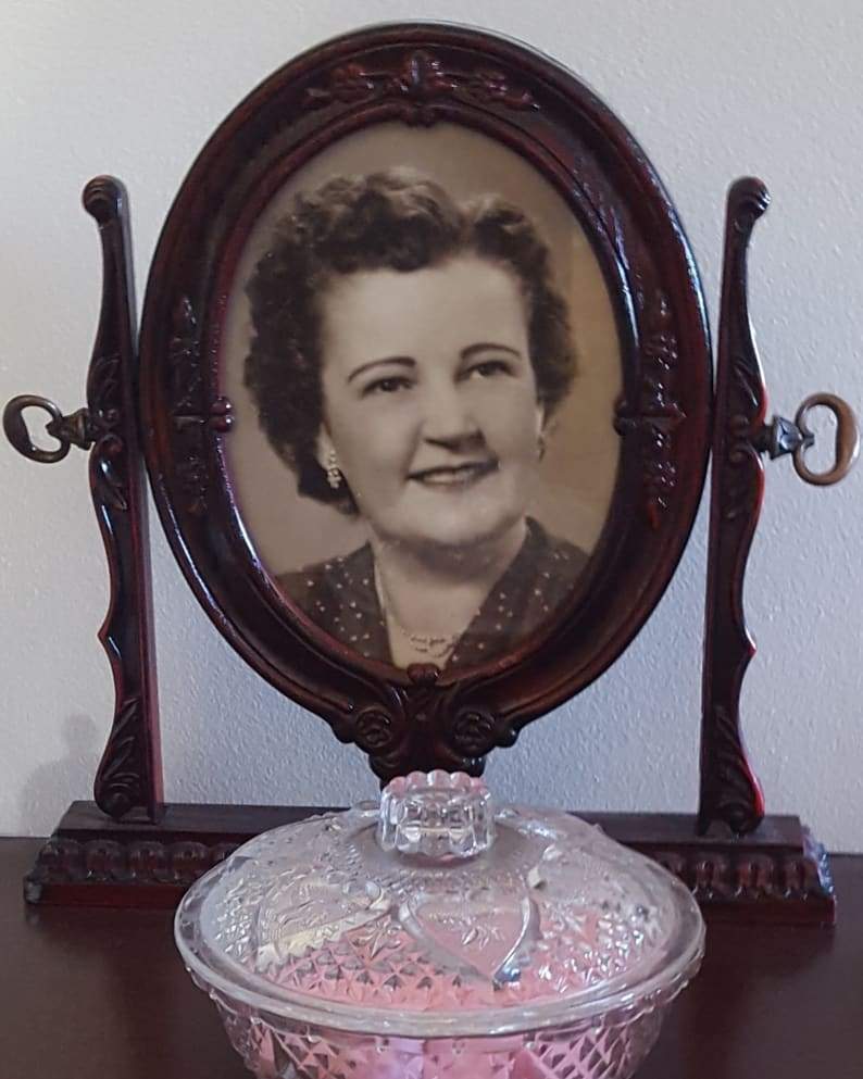 The antique frame containing a photo of Phyllis Clooney.