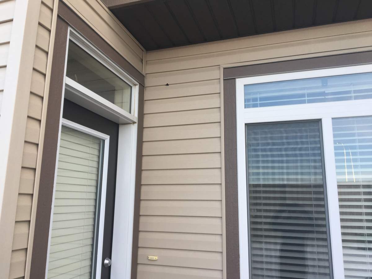 A bullet hole is seen on the outside of a northwest Calgary home.