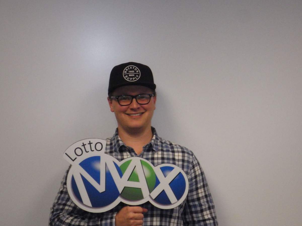 Joshua Caines claims the winning $50 million ticket from the August 30 LOTTO MAX draw. 