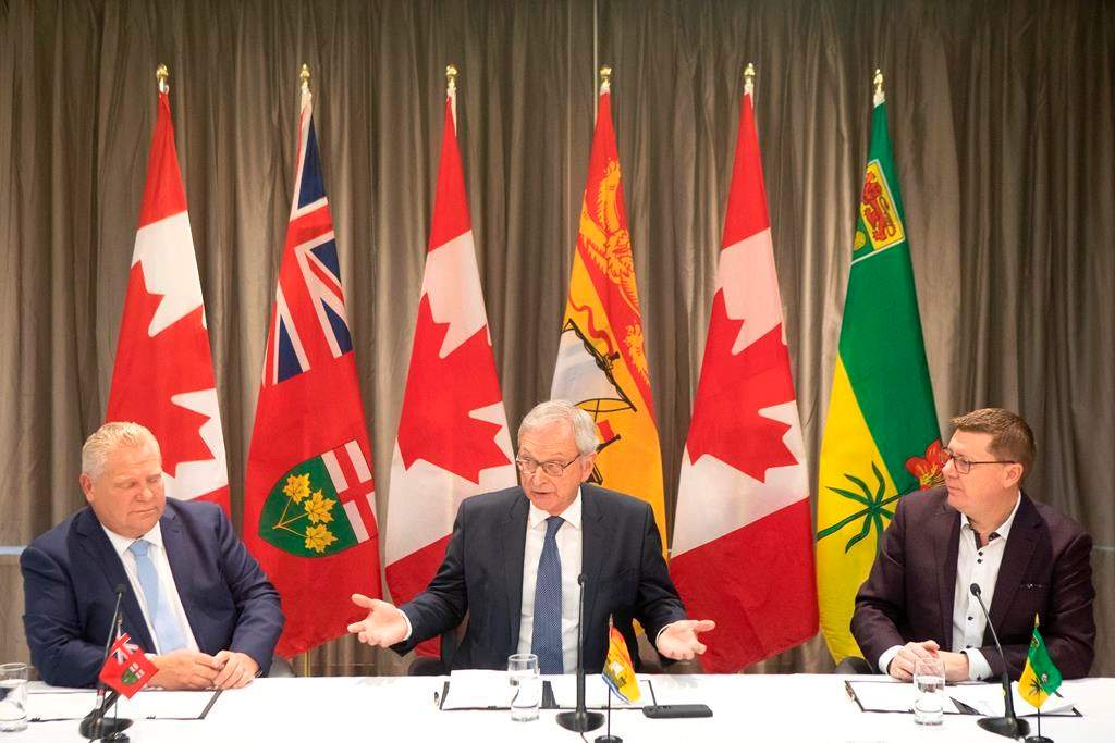 Ontario Premier Doug Ford, left to right, New Brunswick Premier Blaine Higgs and Saskatchewan Premier Scott Moe sit as they talk to the media in Toronto on Sunday, Dec. 1, 2019.