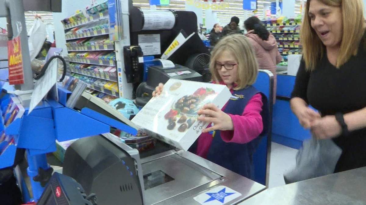 Cloey gets to play cashier and scan her items as part of the CopShop program.
