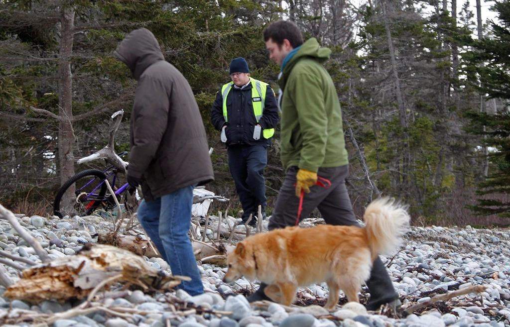 A security guard prepares to confront beach visitors in Hackett's Cove, N.S. on Wednesday March 9, 2016.