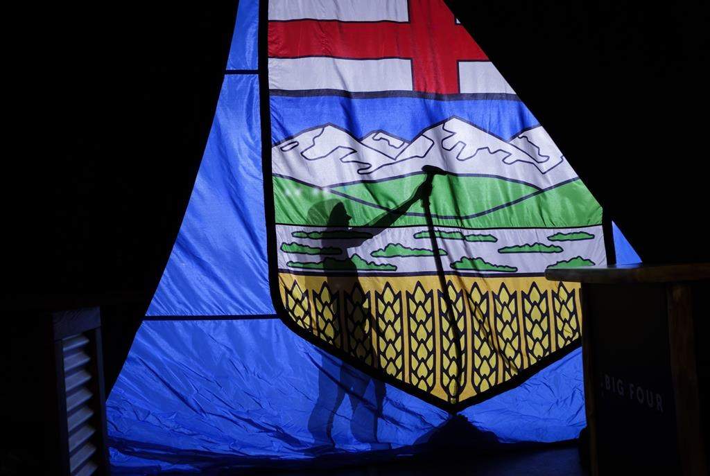 A campaign worker steams the wrinkles from a large Alberta flag at the venue where United Conservative Party Leader Jason Kenney will address supporters, Calgary, Alta., Tuesday, April 16, 2019.