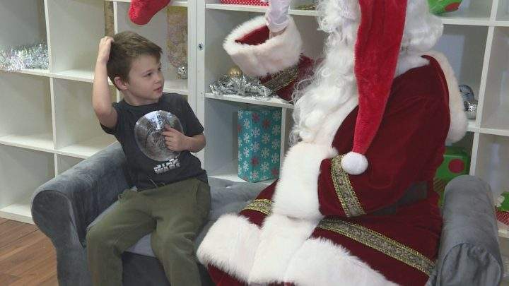 Colleen Ruhl’s son signs his Christmas wishes to Santa in Calgary on Saturday, Dec. 14, 2019.