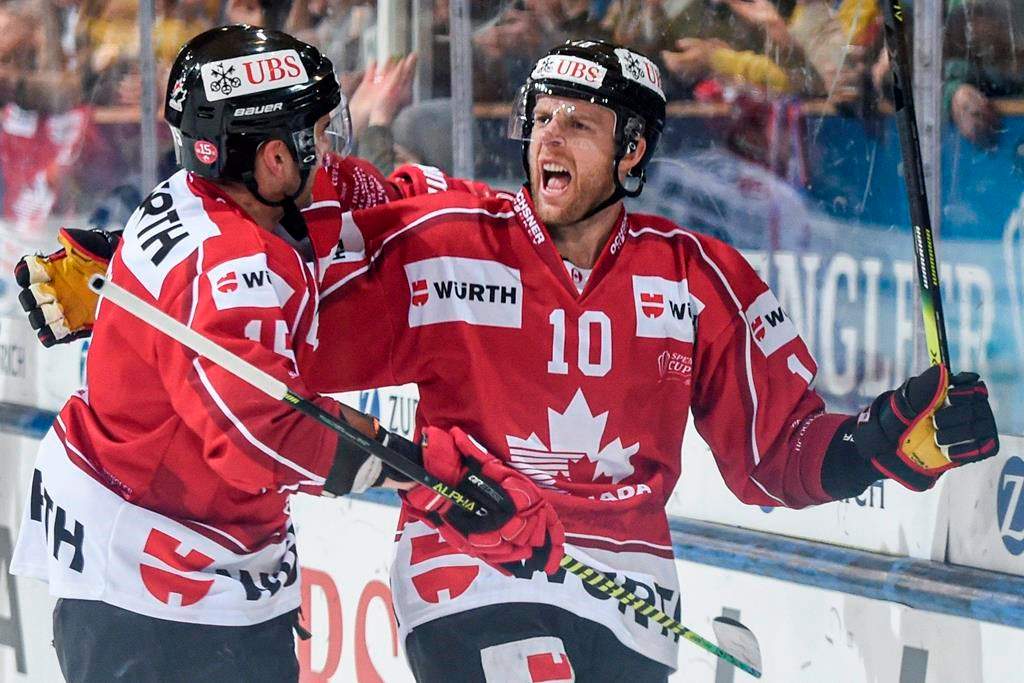 Team Canada's Kris Versteeg celebrates after scoring 3:0 during the game between HC Ambri-Piotta and HC Ocelari Trinec at the 93th Spengler Cup ice hockey tournament in Davos, Switzerland, Monday, Dec.31, 2019. (Melanie Duchene/Keystone via AP).