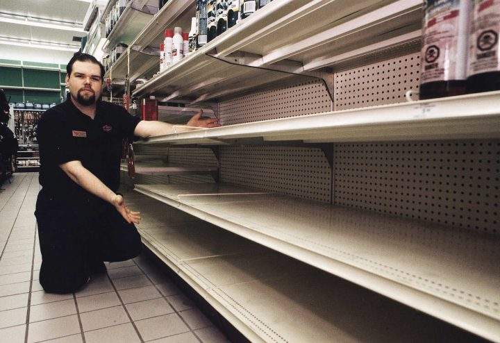 Brad Morningstar, assistant manager of Canadian Tire in Richmond, B.C. displays empty shelves in the camping goods aisle after a suspected rush on returns of merchandise bought because of Y2K fears did not happen, in January 2000.