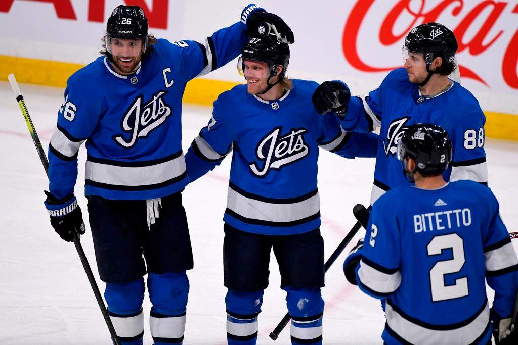 Winnipeg Jets' Nikolaj Ehlers (27) celebrates his goal against the Philadelphia Flyers with teammates Blake Wheeler (26), Nathan Beaulieu (88) and Anthony Bitetto (2) during first-period NHL action in Winnipeg on Sunday, Dec. 15, 2019.