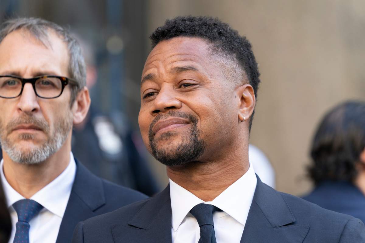 Actor Cuba Gooding Jr. listens as his attorney Mark Heller addresses press after his arraignment in New York state Supreme Court in the Manhattan. 
