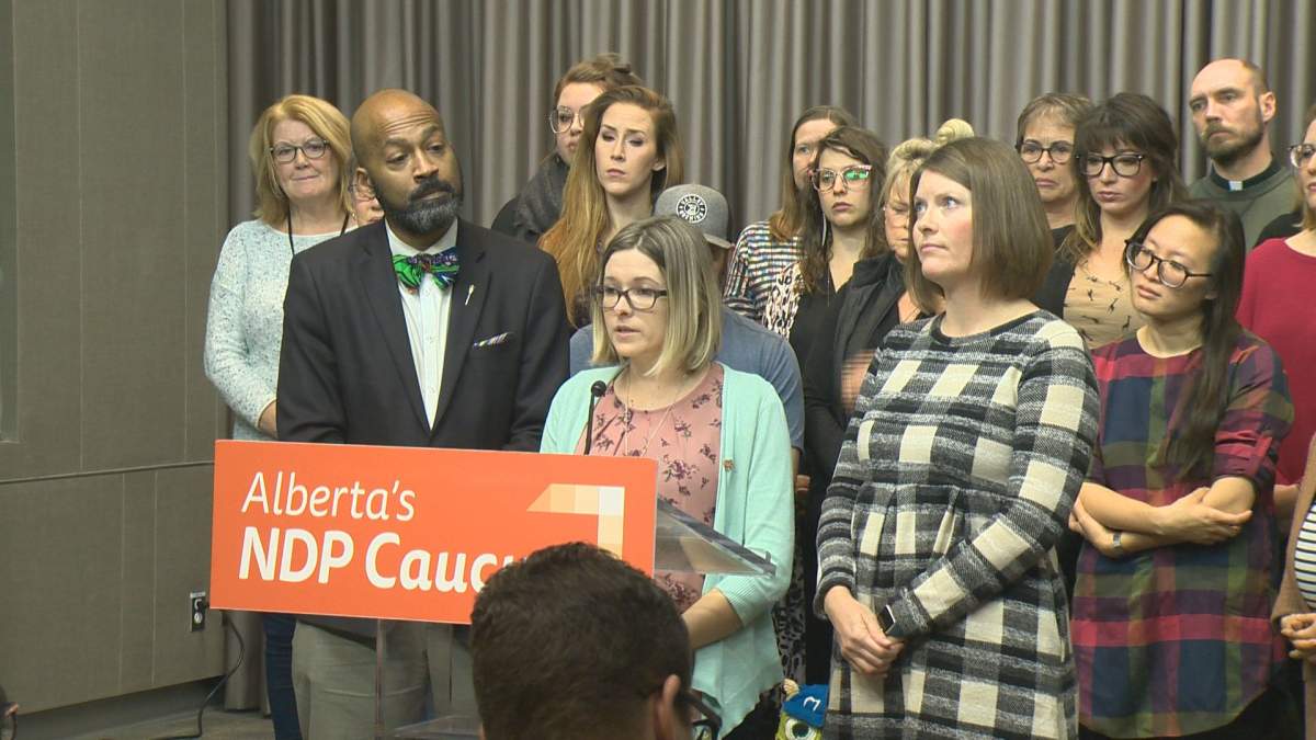 Front line workers, including Dr. Bailey Adams (centre) joined MLA David Shepherd at the Edmonton Federal Building on Tuesday, Dec. 3, to speak out against health care cuts in the province.