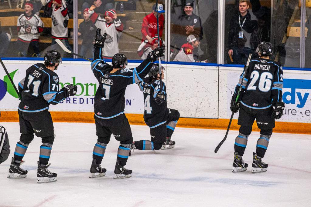 Winnipeg ICE players Michal Teply, Carson Lambos, Connor McClennon and Reece Harsch celebrate a goal.