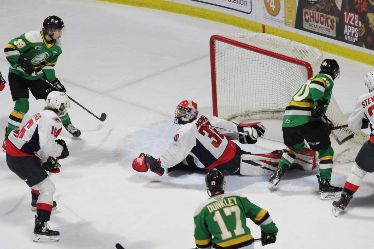 The London Knights zoom around Spitfires goalie Xavier Medina. Medina made 39 saves in a 6-3 Windsor victory on Dec. 15, 2019.