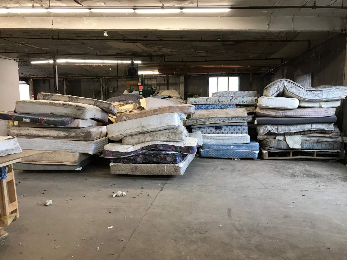Piles of old mattresses waiting to be stripped down.