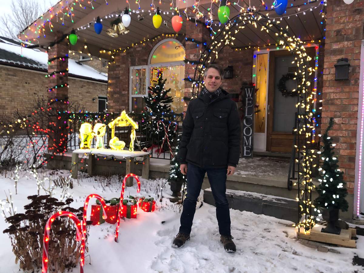 Nathan Oegema in front of his house decorations at 2 Eric Dr. in Dorchester.