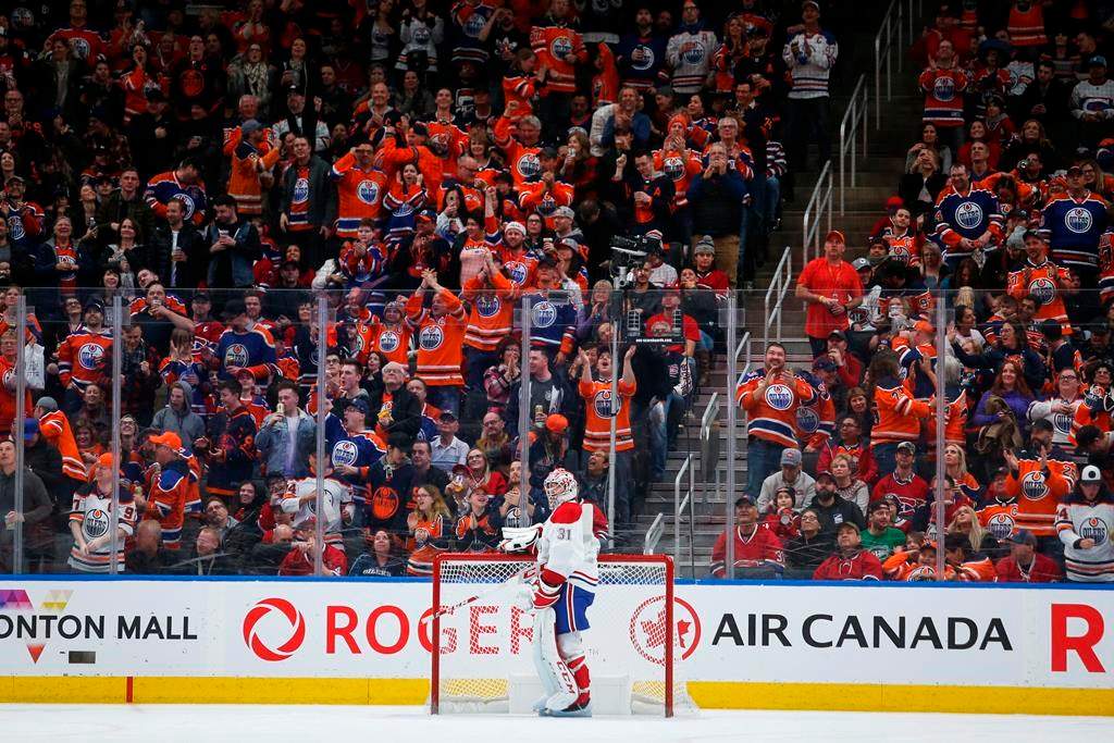 Montreal Canadiens goalie Carey Price, centre, looks away as Edmonton Oilers' fans cheer the game-winning goal during third period NHL hockey action in Edmonton, Saturday, Dec. 21, 2019.