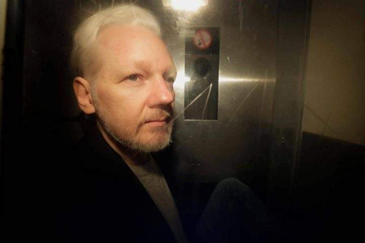 FILE - In this Wednesday May 1, 2019 file photo, WikiLeaks founder Julian Assange is taken from court, where he appeared on charges of jumping British bail seven years ago, in London. The alleged rape investigation involving WikiLeaks founder Julian Assange, who is currently in prison in Britain, has been discontinued, a Swedish prosecutor said Tuesday Nov. 19, 2019. (AP Photo/Matt Dunham, File).