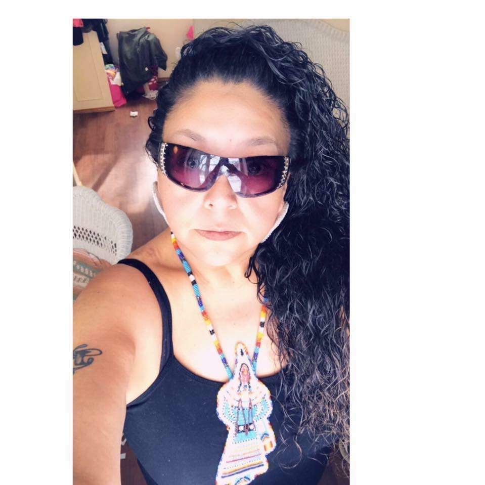 Mish Daniels wearing one of her handmade beaded medallions